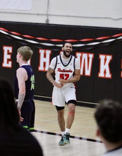 Malik celebrating on the court wearing number 57.